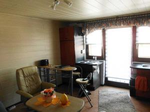 a living room with a table and a kitchen at Ferienwohnung Anneli Edert in Bad Harzburg +3 photos