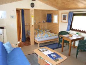a room with a bed and a table in a room at Ferienhaus Walnuss-Hütte in Bad Harzburg