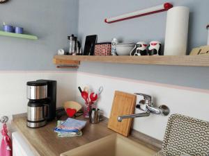 a kitchen counter with a coffee maker and a sink at Appartement "Charming Harzburg" in Bad Harzburg