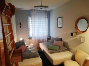 a living room with a couch and a window at Appartement "Charming Harzburg" in Bad Harzburg