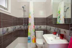 a bathroom with a toilet and a sink at Suite For You in Nicosia