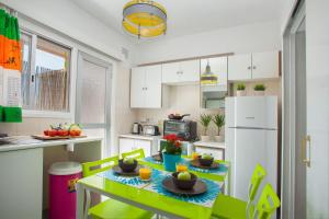 a kitchen with a green table and a white refrigerator at Suite For You in Nicosia +16 photos