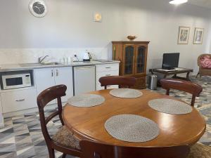 a kitchen with a wooden table and chairs and a kitchen with a sink at Southerly Studio in Augusta