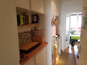 a kitchen with a counter and a dog in the distance at Ferienwohnung Schnuffi Wolfgang Kresse in Bad Harzburg