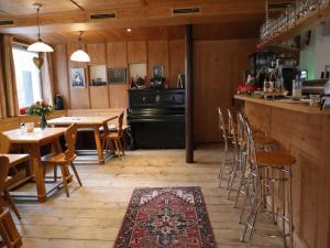 a restaurant with tables and chairs and a bar at Holiday apartment in Bregenzerwald in Sibratsgfäll