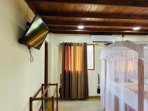 a bedroom with a bed and a window at Green Heaven Sigiriya in Sigiriya