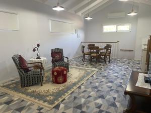 a living room with chairs and a table in it at Southerly Studio in Augusta