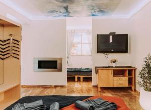 a living room with a flat screen tv on a wall at Centrum Apartman in Balatonfenyves