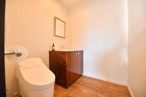 a bathroom with a toilet and a sink at Buckeye House by the lake in Yamanakako