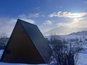a building that is standing in the snow at Aurora Cottage Tabatskuri Lake in Tabatsquri +6 photos