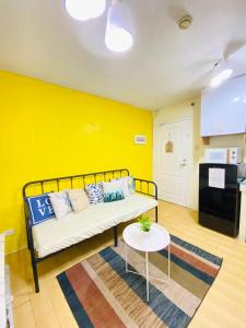 a living room with a couch and a table at Your Comfort Zone Staycation1 in Manila