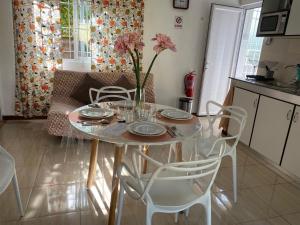 a table with a vase of flowers on it in a kitchen at Villa Capri first floor in Quatre Bornes