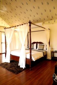 a bedroom with a canopy bed in a room at Innara Hospitality in Mori Bera +25 photos