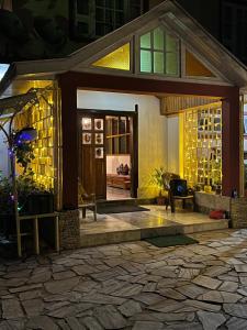a house with a stone floor and a front porch at Ifseen Villa in Pelling +18 photos