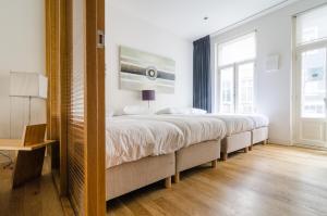 a bedroom with two large beds in it at Marnix360apartments Design in Amsterdam