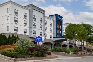 a building with a blue sign in front of it at Hampton Inn by Hilton Kamloops in Kamloops