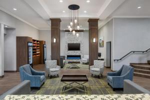 a lobby with chairs and a table and a tv at Hampton Inn by Hilton Kamloops in Kamloops