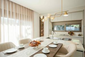 a kitchen and dining room with a table and chairs at Villa Kennedy in Faliraki