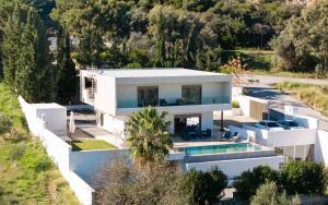 an aerial view of a white house with a swimming pool at Villa Kennedy in Faliraki