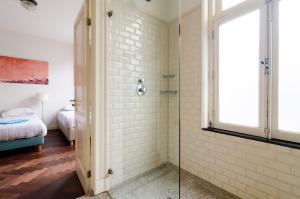 a bathroom with a shower with a glass door at Marnix360apartments Classic in Amsterdam +20 photos