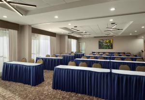 a conference room with blue tables and chairs at Hilton Garden Inn Jackson-Madison in Madison +20 photos