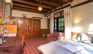 a bedroom with a bed and a chair in a room at Timberwolves Vintage Manali in Manāli