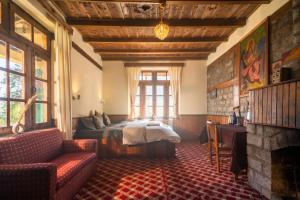 a bedroom with a bed and a couch and a window at Timberwolves Vintage Manali in Manāli