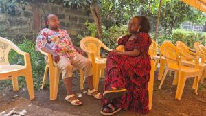 a man and a woman sitting on chairs at Kiwis home in Nakuru