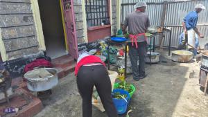a group of people standing outside of a house at Kiwis home in Nakuru