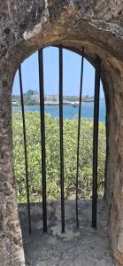 a window in a stone wall with a view of a field at Kiwis home in Nakuru