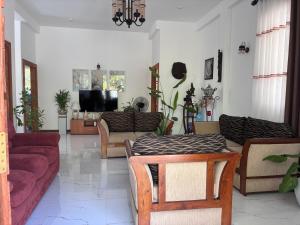 a living room with a couch and a table at Handagedara Madiha Villa in Matara