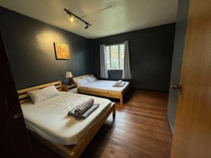 a room with two beds and a window at Lualhati Homestay in Baguio