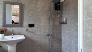a bathroom with a shower and a sink at Handagedara Madiha Villa in Matara
