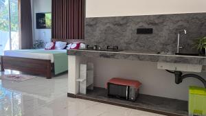 a bedroom with a bed and a sink and a sink at Handagedara Madiha Villa in Matara