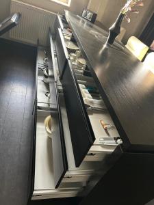 a kitchen with black cabinets and an open drawer at Ferienwohnung Müritz-Blick in Waren +7 photos