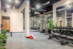 a gym with rows of treadmills and machines at Stella Stays King Fahd - Furnished Apartments in Riyadh