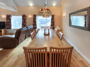a living room with a table and chairs and a couch at Pilots Loft in Menai Bridge