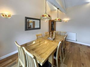 a dining room with a wooden table and chairs at Pilots Loft in Menai Bridge