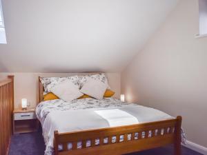 a bedroom with a large bed with pillows at The Old Dairy in Nether Broughton