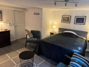 a bedroom with a bed and a desk and a chair at Kilimanjaro & Stayover in Svinninge