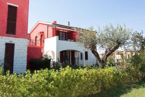 a white house with a red brick building at Adamo Ed Eva Resort in Numana