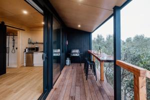 a kitchen and dining area of a house with a deck at Casa Olea in Waipara