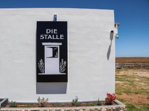 a white building with a die strike sign on it at Die Stalle by Chickania in Jacobs Bay