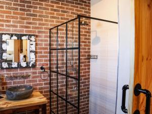 a bathroom with a sink and a brick wall at Die Stalle by Chickania in Jacobs Bay +20 photos