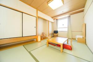 an empty room with a table and a window at Hotel Hiroshima Sunplaza in Hiroshima