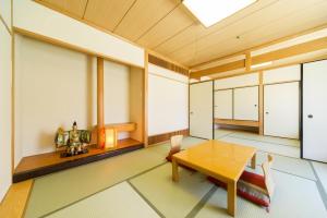 a dining room with a wooden table and chairs at Hotel Hiroshima Sunplaza in Hiroshima