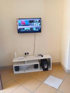 a living room with a tv on a wall at milina homes in Ukunda