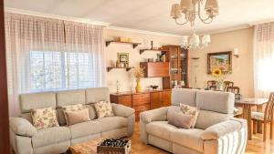 a living room with a couch and a table at Chalet en La Rioja para familias y grupos in Tricio