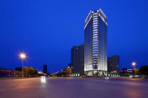 a large building at night with a parking lot at SSAW Boutique Hotel Dexin Mogan Mountain in Deqing