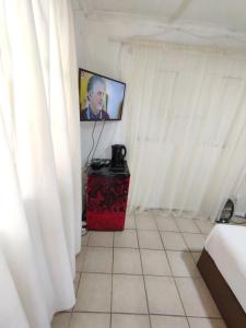 a room with a television and a tiled floor at 26 molen street in Rustenburg
